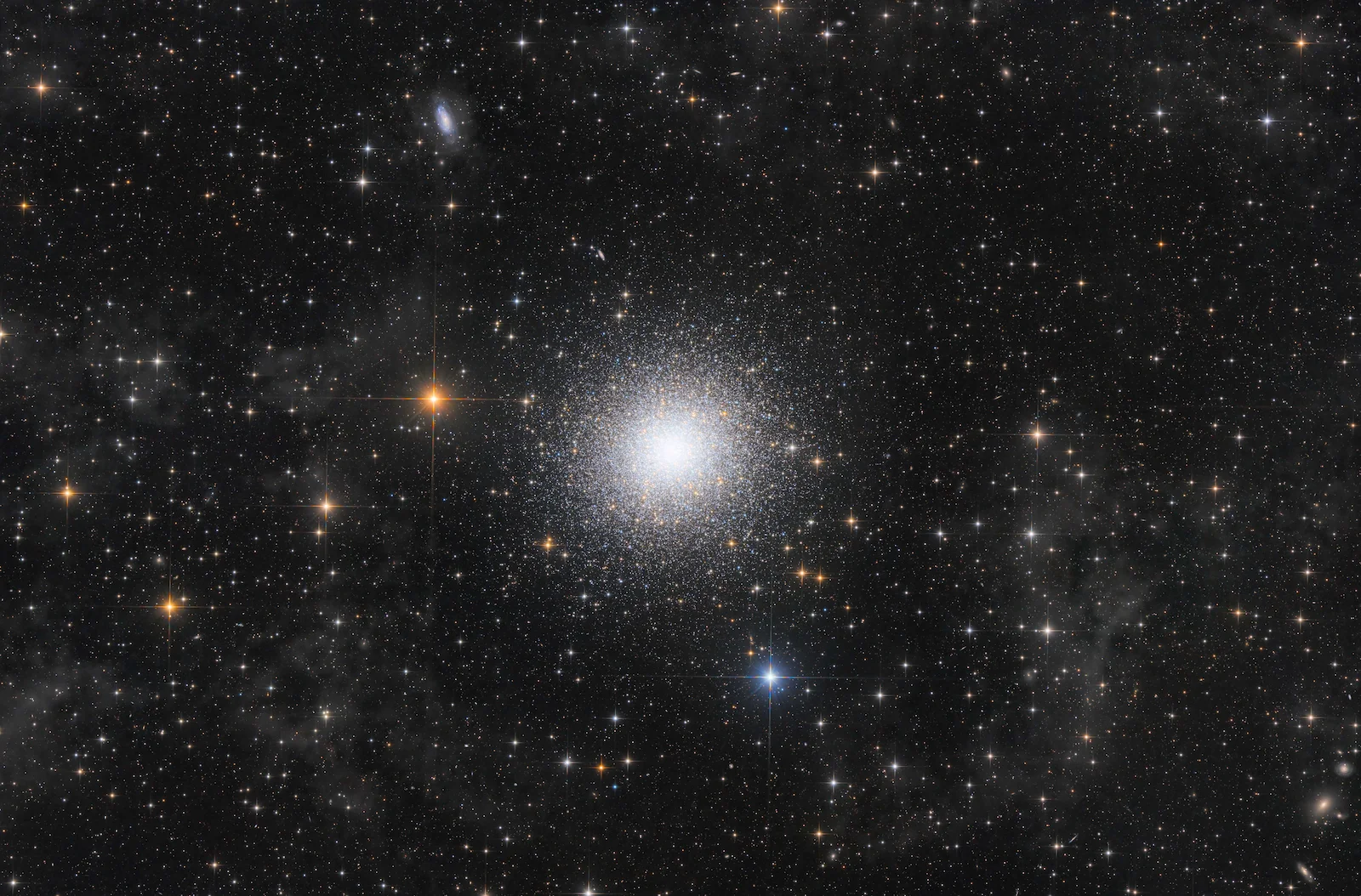 An image showing the dense sparkling core of the M13 globular cluster with hundreds of thousands of stars packed tightly together against a dark background